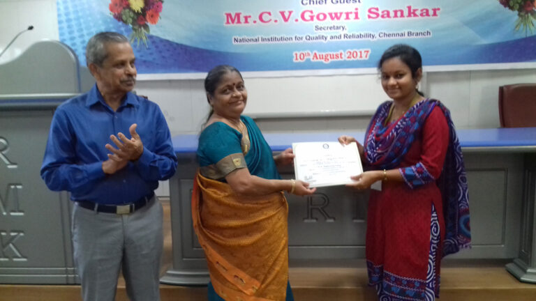 Mrs. Uma Gowi Sankar presenting the certificate